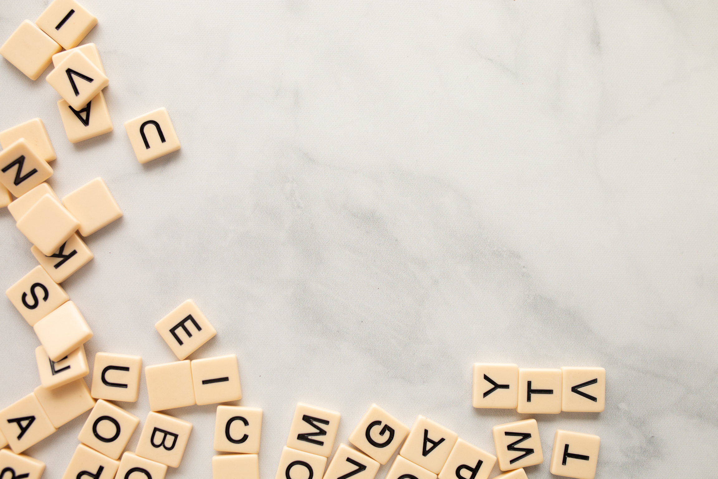 Scrabble Tiles on a Marble Background Flatlay